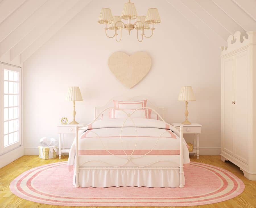 pink attic room white bed frame and cabinets