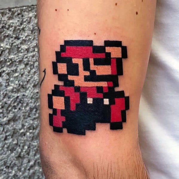 Retro *Super Mario* tattoo featuring an 8-bit pixel design in bold black and red, capturing the nostalgic essence of classic gaming.
