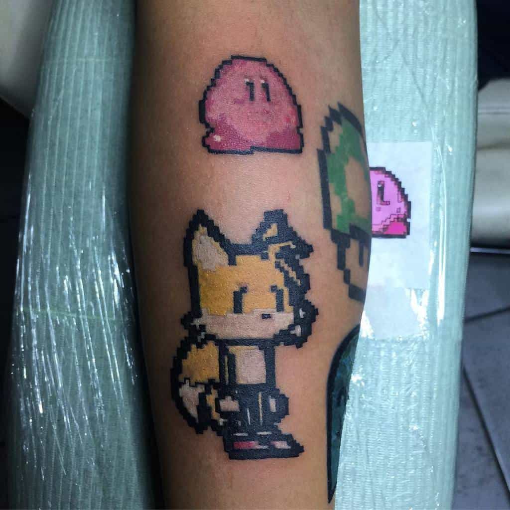 Pixel art-style tattoo featuring Kirby and Tails from Sonic, designed in a retro video game aesthetic
