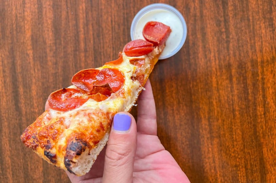 pizza being dipped into ranch dressing