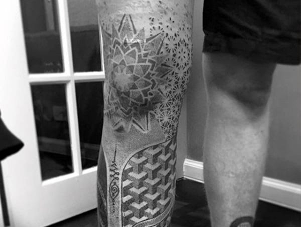 Leg tattoo for men featuring intricate geometric and mandala patterns with dotwork and 3D-style elements.