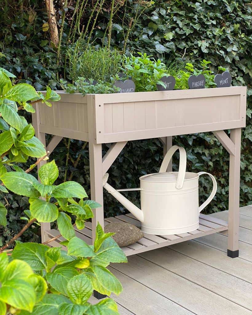 small planter box herb garden with watering can