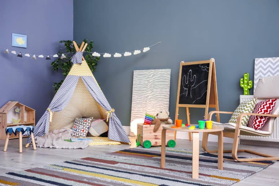 colorful playroom with teepee tent and chalkboard
