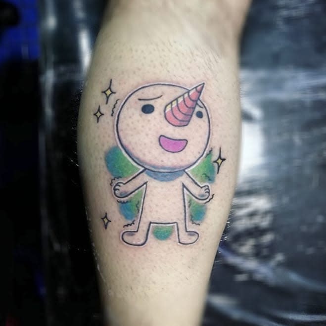 Colorful tattoo of Plue from Fairy Tail, featuring a whimsical design with a pastel color palette, sparkles, and a cheerful expression.