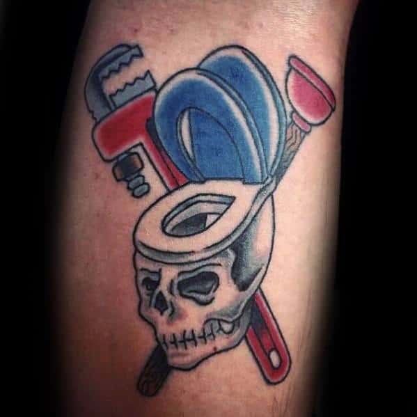 Tattoo of a skull-shaped toilet with a plunger, wrench, and tape roll forming a bold plumbing-themed design with a dark twist.