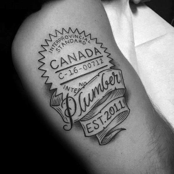 Black and grey tattoo of a Canadian Interprovincial Standard seal with a flowing banner reading Plumber EST. 2011 and certification details.