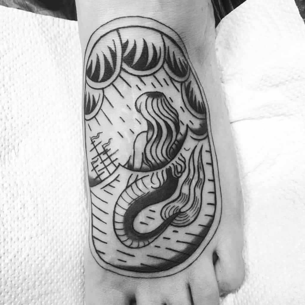 Blackwork tattoo of a mermaid with flowing hair, sitting in stormy waters, gazing at a distant ship, framed within a wave design.