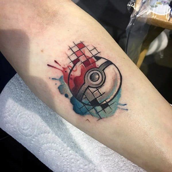 Watercolor Pokeball tattoo with red and blue splashes, grid pattern overlay, and sketch-style shading for a creative, artistic vibe on the arm.