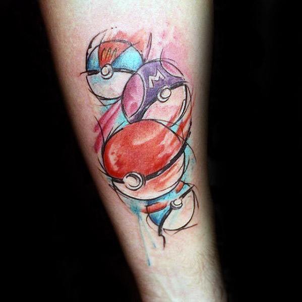 Artistic forearm tattoo featuring multiple Pokeballs in a loose watercolor and sketch style, with splashes of red, blue, and purple.