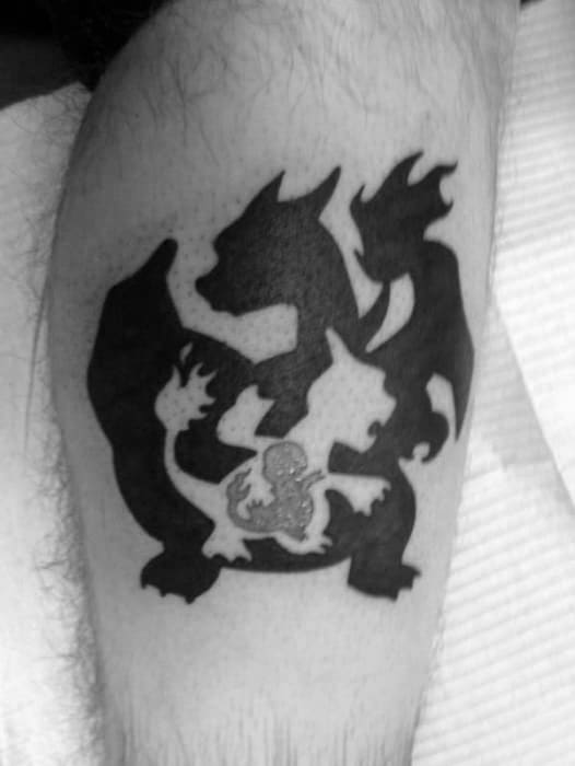 Black ink silhouette tattoo of Charizard and Charmeleon with a bright white Charmander outline in the center, symbolizing their evolution path.