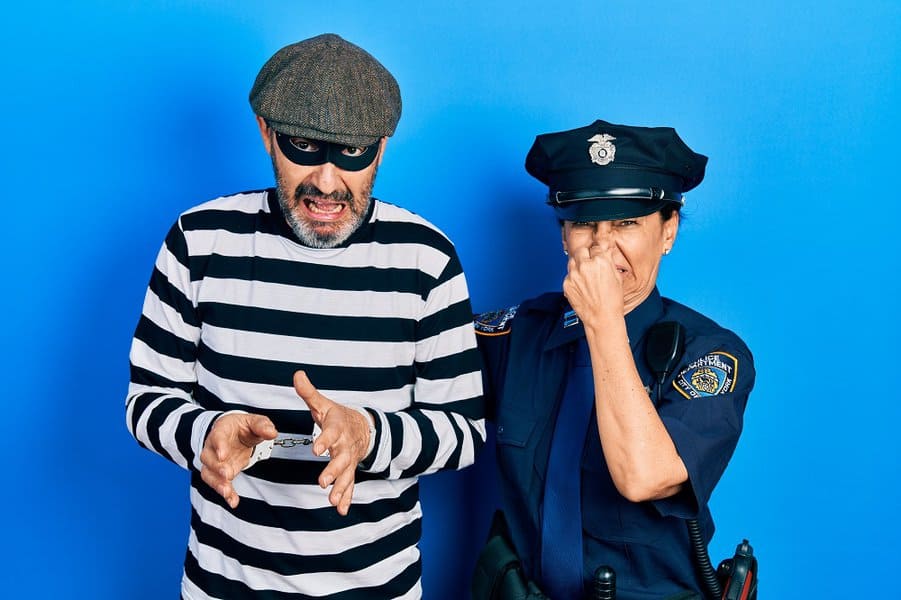 police woman and man wearing thief