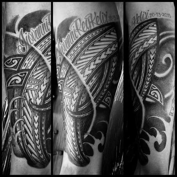 Polynesian shark tattoo sleeve with bold tribal patterns, ocean waves, and names inscribed, symbolizing strength, heritage, and personal meaning.
