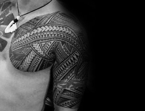 Polynesian tribal tattoo covering shoulder and upper arm with intricate patterns symbolizing strength, heritage, and warrior identity.