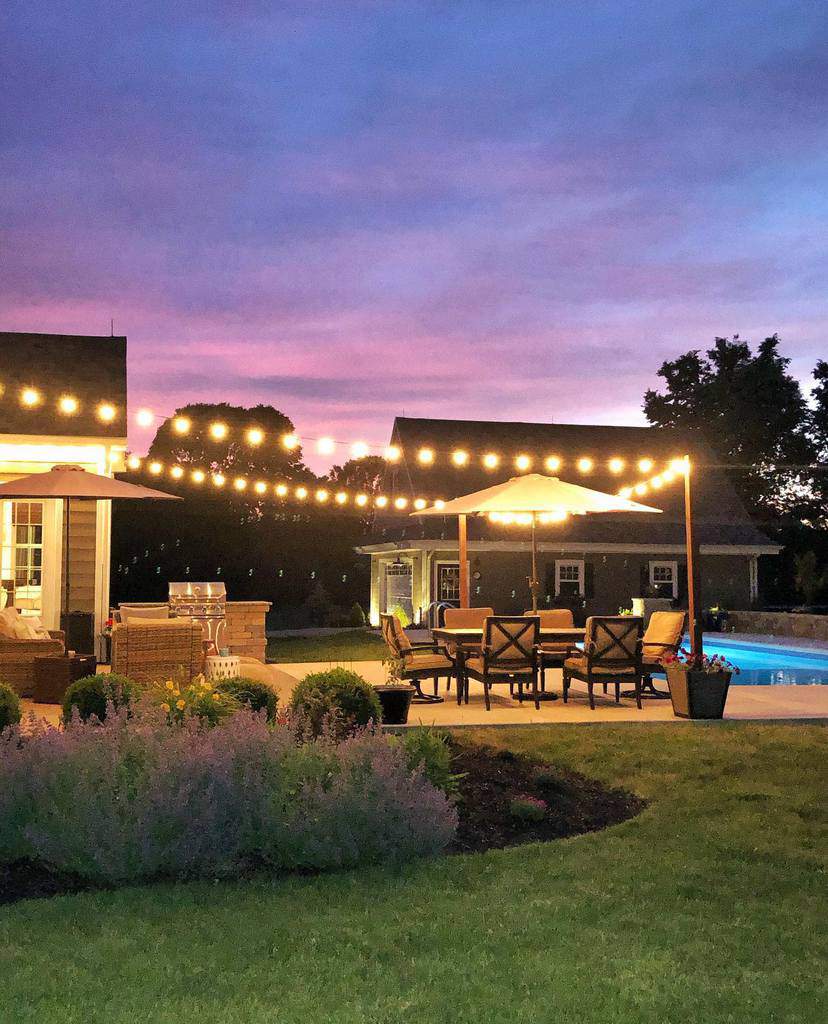 large patio with bbq and string lights
