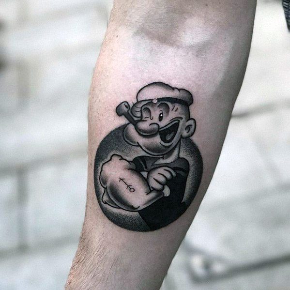 Black and grey Popeye tattoo with arms crossed inside a shaded circle, showing his iconic anchor tattoo and pipe grin.