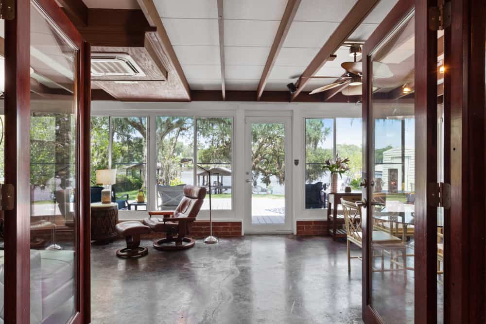 concrete floor porch enclosed patio eames lounge chair ceiling fan