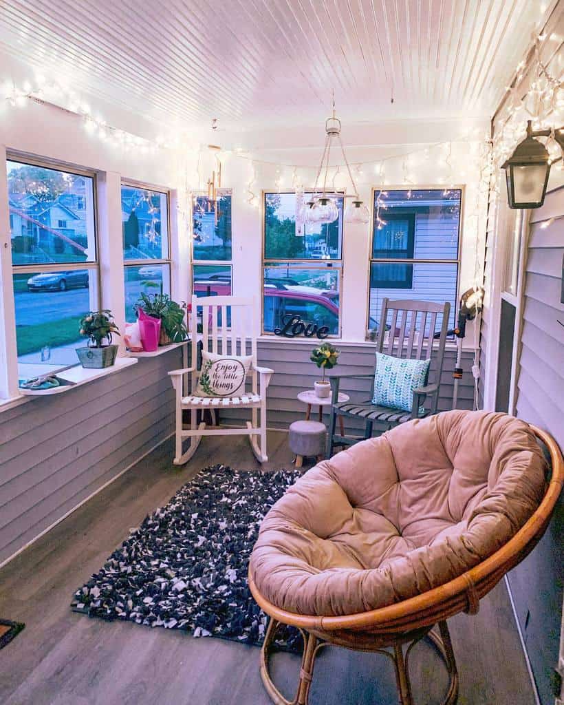 two tone white and gray shiplap front porch fairy lights rocking chairs 