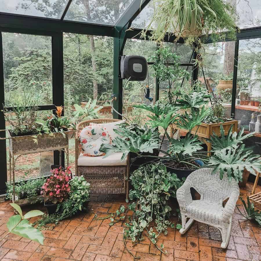 green frame porch greenhouse wood planters wicker chairs