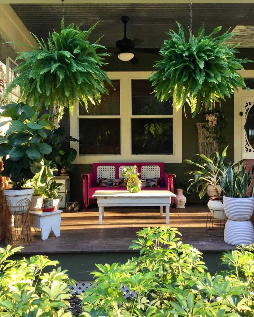 country home porch with red sofa and white vintage table