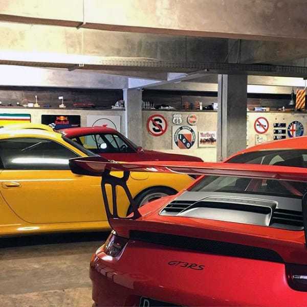 Industrial-themed garage showcasing vibrant Porsche GT3 RS models.
