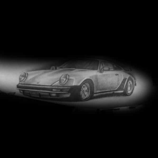 Classic Porsche tattoo in soft grayscale shading, highlighting its iconic silhouette and vintage charm.