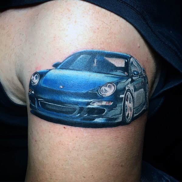 Vivid blue Porsche tattoo on the upper arm, capturing sleek reflections and realistic detail.