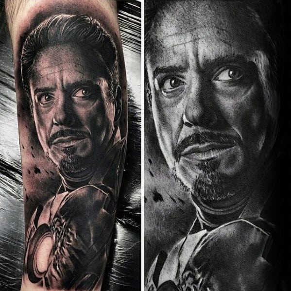 Iron Man tattoo featuring a stunning black and gray portrait of Tony Stark, with his face and arc reactor captured in intricate detail, showcasing his intense expression.