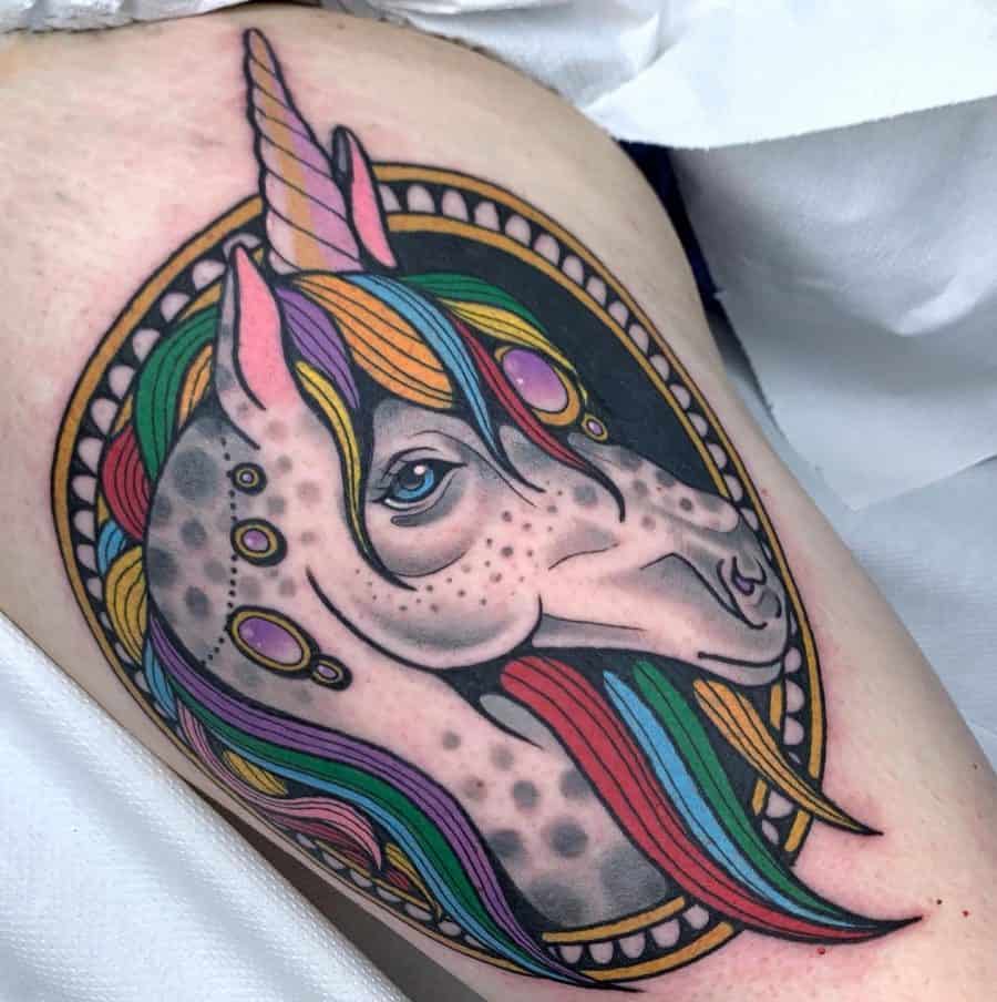 Vibrant neo-traditional unicorn tattoo with a rainbow mane, ornate jewel details, and a decorative oval frame for a bold, mystical look.
