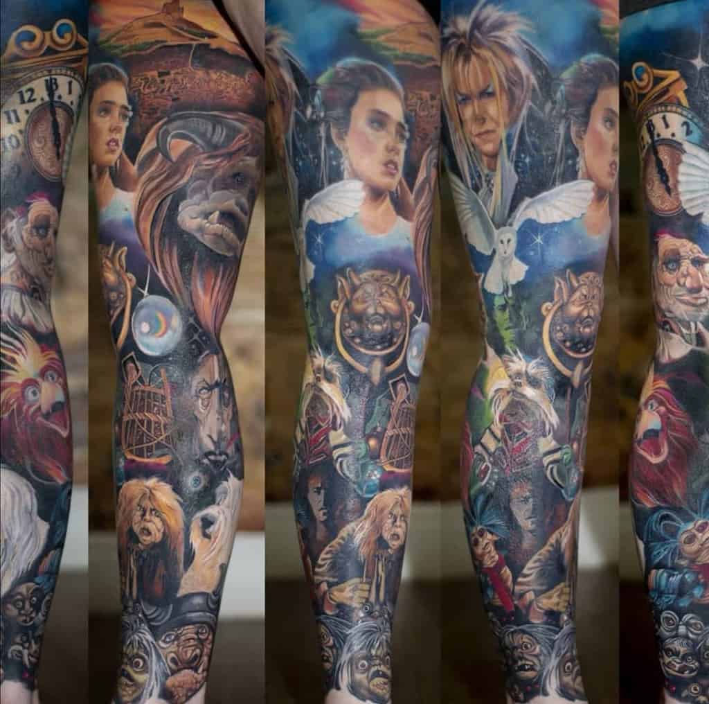 Vivid tattoo leg sleeve inspired by the movie Labyrinth, featuring iconic characters such as Jareth, Sarah, and the Labyrinth creatures, along with detailed elements like clocks, owls, and fantastical imagery