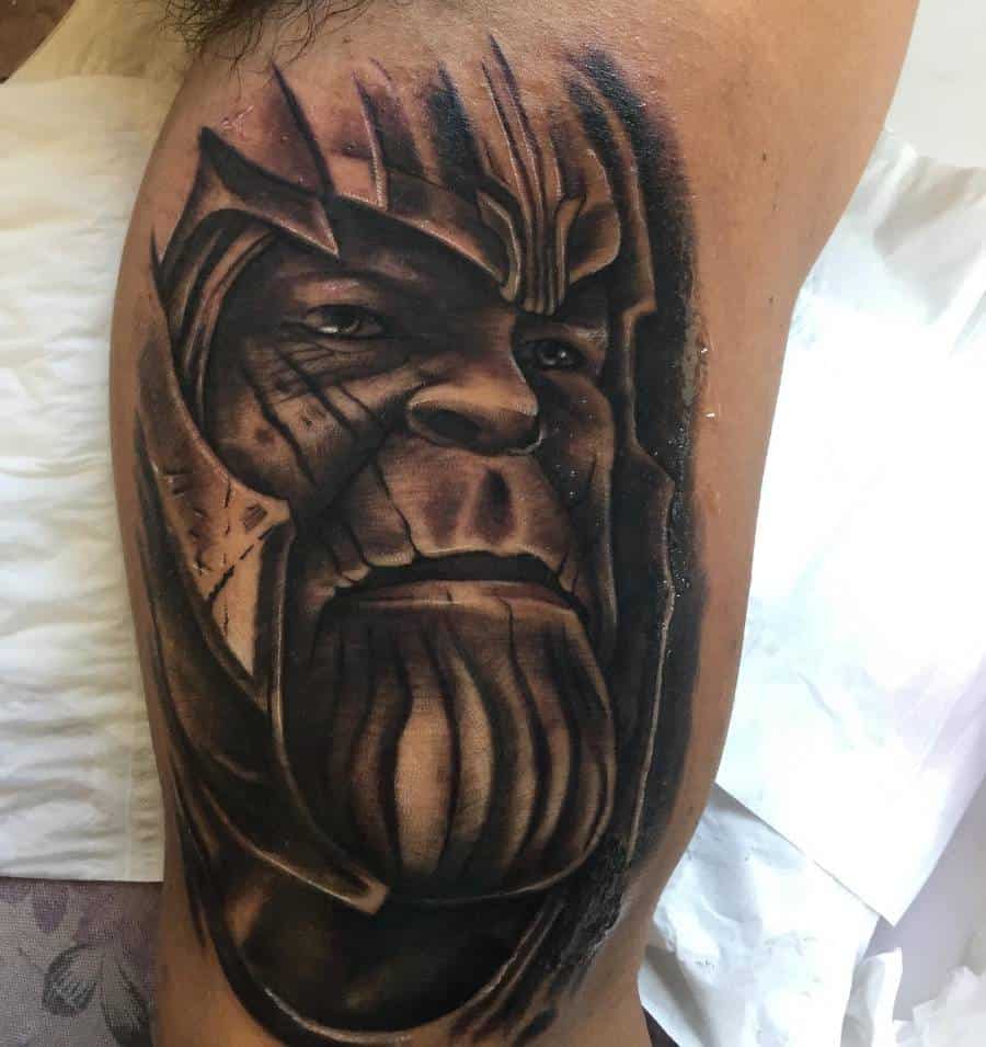 A hyper-realistic black and gray Thanos tattoo showcasing deep shading, fine details, and an intense expression