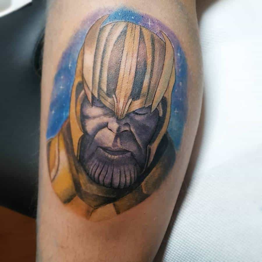 A vibrant tattoo of Thanos, showing his face with a serious expression, detailed with colorful background that highlights his helmet and features