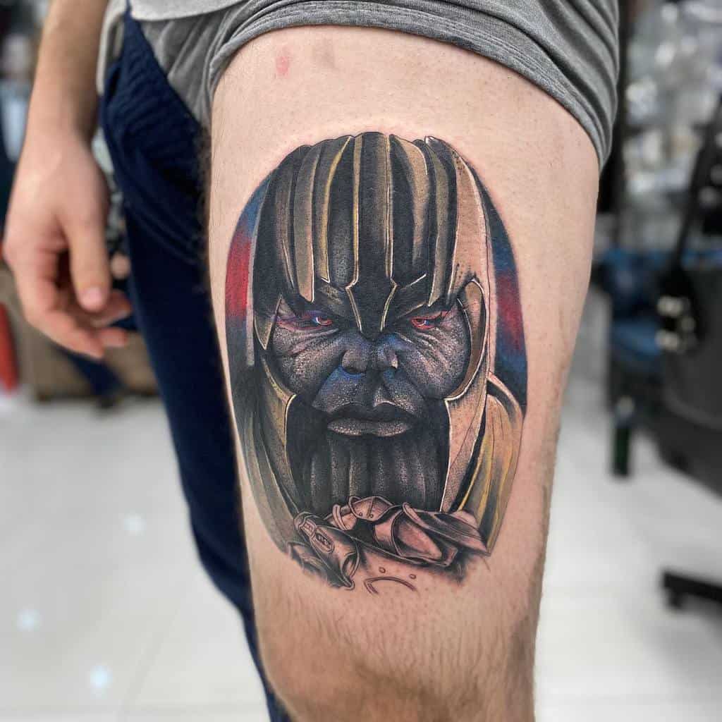 A vivid tattoo of Thanos, showing his intense expression, a colorful background, and his hand holding the Infinity Gauntlet