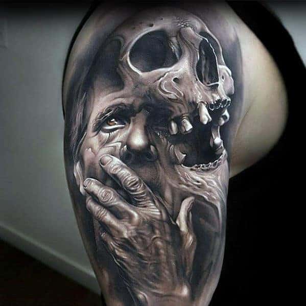 Black and grey tattoo of a skull merging with a face and a hand covering the mouth