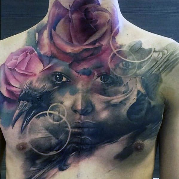 Chest tattoo of a face, roses, raven, and abstract designs