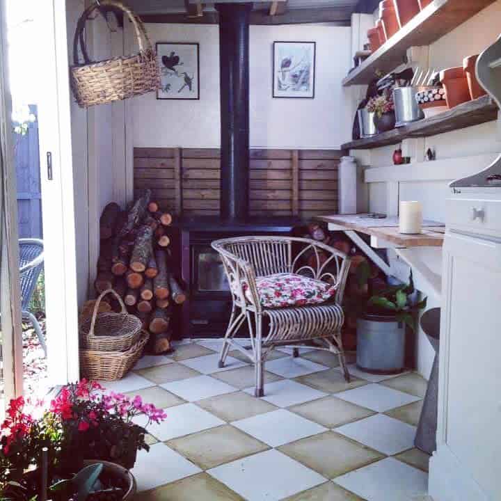 small she shed with fireplace and bench