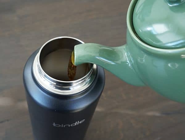 Pouring Strawberry Tea Into Top Of Stainelsss Steel Bindle Bottle