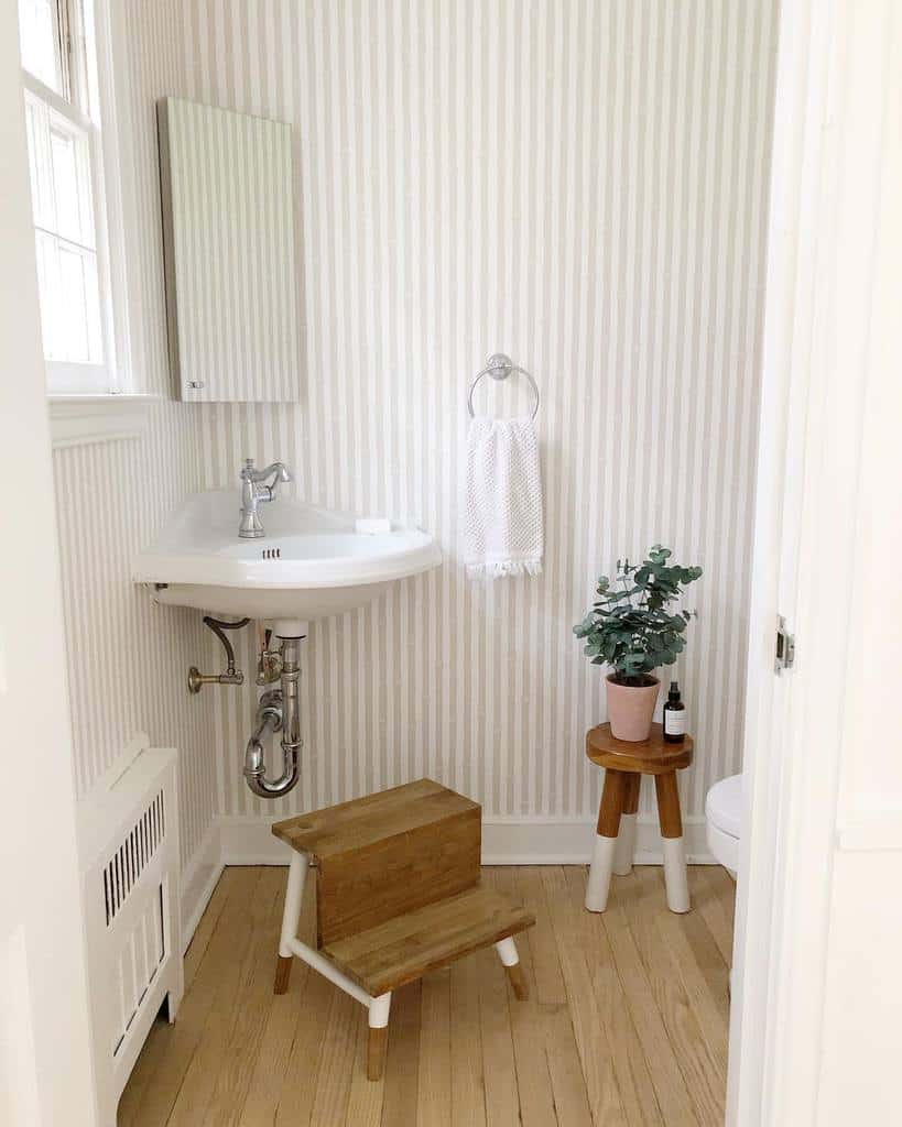 rustic powder room corner sink wood steps small pot plant stripe wallpaper