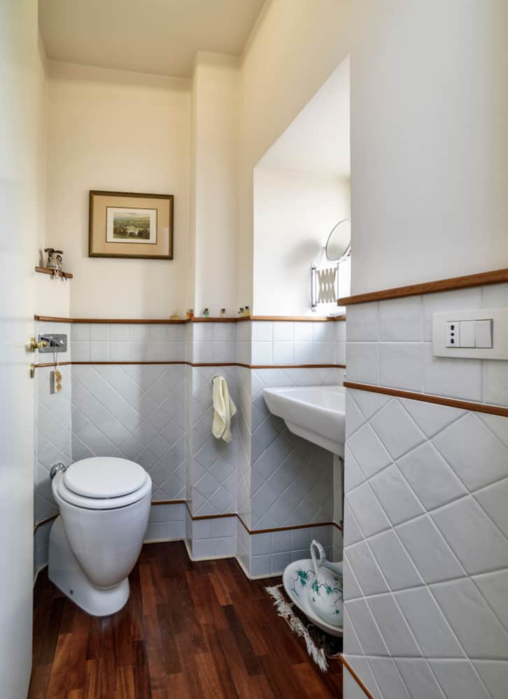 white tile bathroom with wood accents
