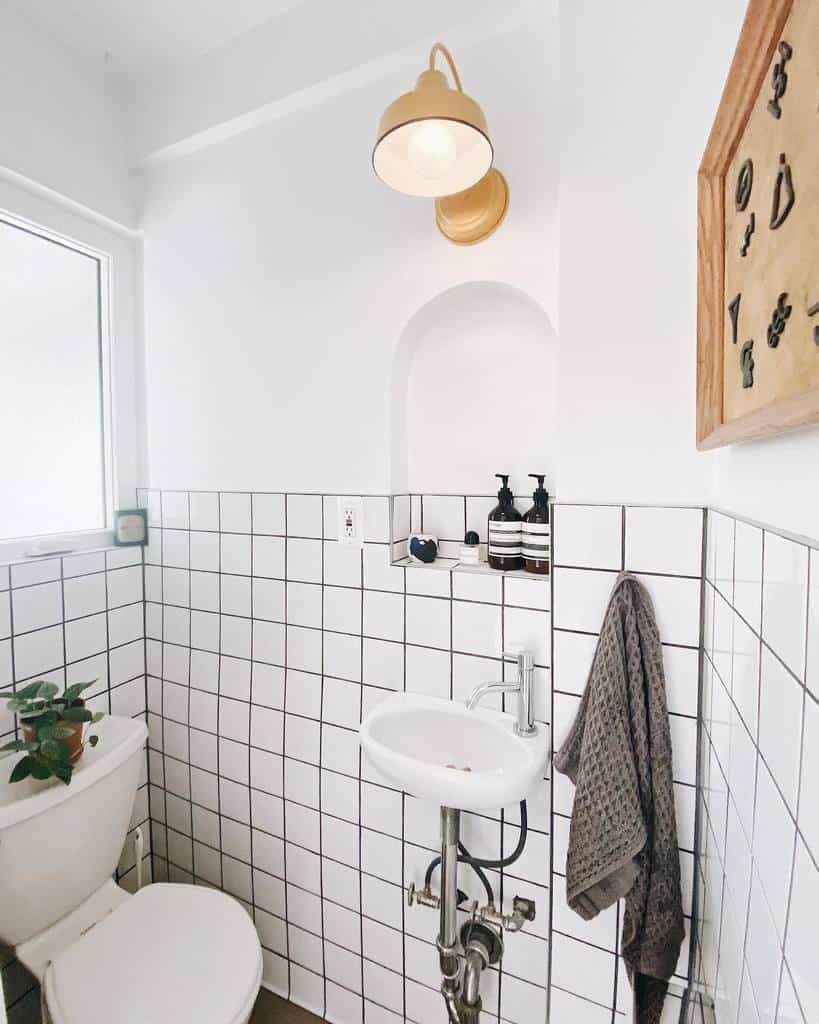 white tile vintage style powder room
