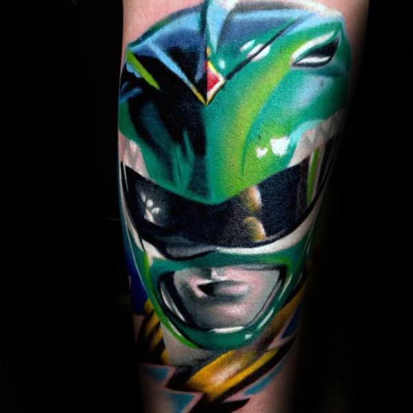 Vibrant Green Ranger helmet tattoo with smooth gradients, sharp highlights, and a polished, high-contrast finish on the forearm.
