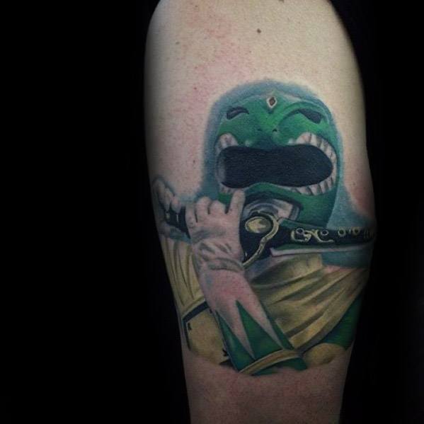 Realistic Green Ranger tattoo playing the Dragon Dagger, with soft shading, detailed textures, and a glowing green aura effect.