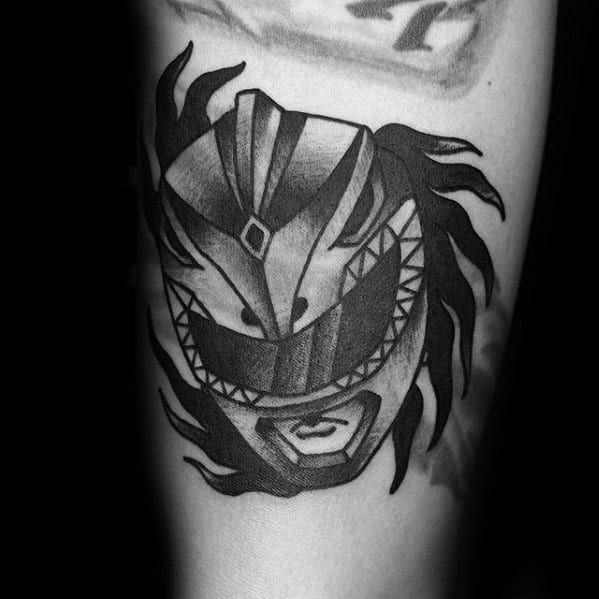 Black and grey tattoo of the White Ranger helmet with bold shadows, flowing flame-like accents, and a fierce, stylized design.