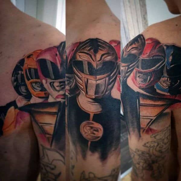 Upper arm tattoo sleeve featuring the Yellow, Red, and White Rangers in dynamic poses with bold shading, armor details, and soft highlights.