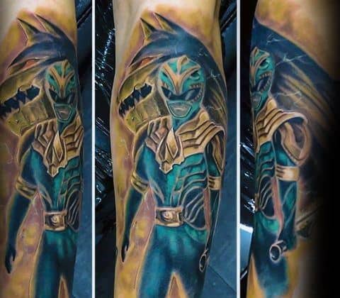 Full-sleeve Green Ranger tattoo in a mystical blue and gold tone, featuring the Dragonzord in the background with a glowing, ethereal effect.
