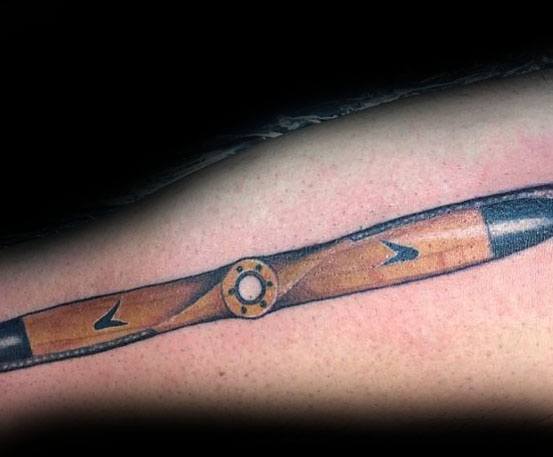 Color forearm tattoo of a vintage wooden propeller with realistic shading, metal accents, and subtle details for a classic aviation-inspired look.