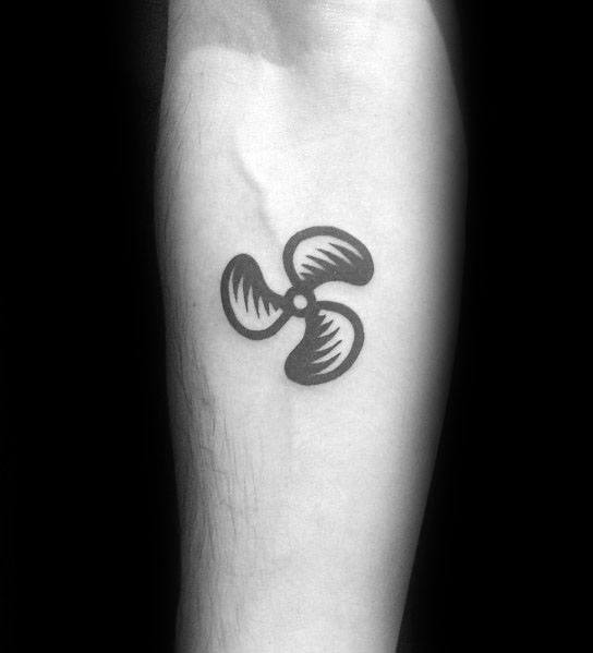 Minimalist black ink forearm tattoo of a three-blade propeller with bold shading and clean lines for a simple yet striking design.