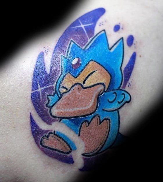 Stylized Golduck tattoo with a playful pose and swirling purple energy, inked on a man's arm in a cartoon-inspired design.