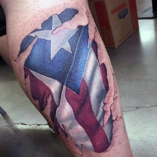 Puerto Rican flag tattoo with a torn skin effect on the leg, revealing bold red, white, and blue colors with a striking star design.