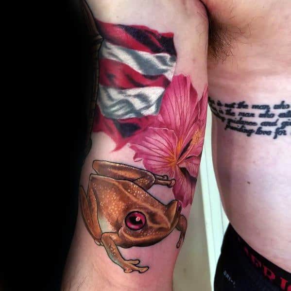 Puerto Rican flag tattoo with a coquí frog and hibiscus flower, symbolizing national pride, nature, and cultural heritage.