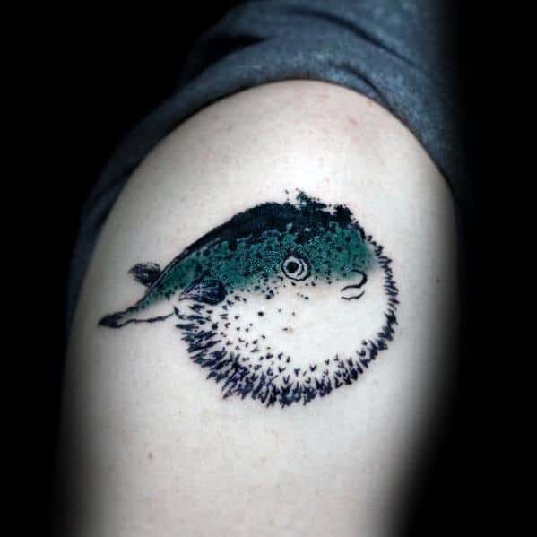 Minimalist pufferfish tattoo with soft shading, dark green and black hues, and fine details, creating a delicate and realistic look.